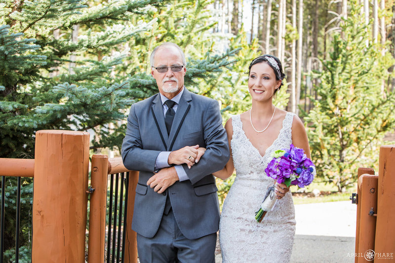 Bride walks with her dad down aisle at BlueSky Breckenridge Colorado