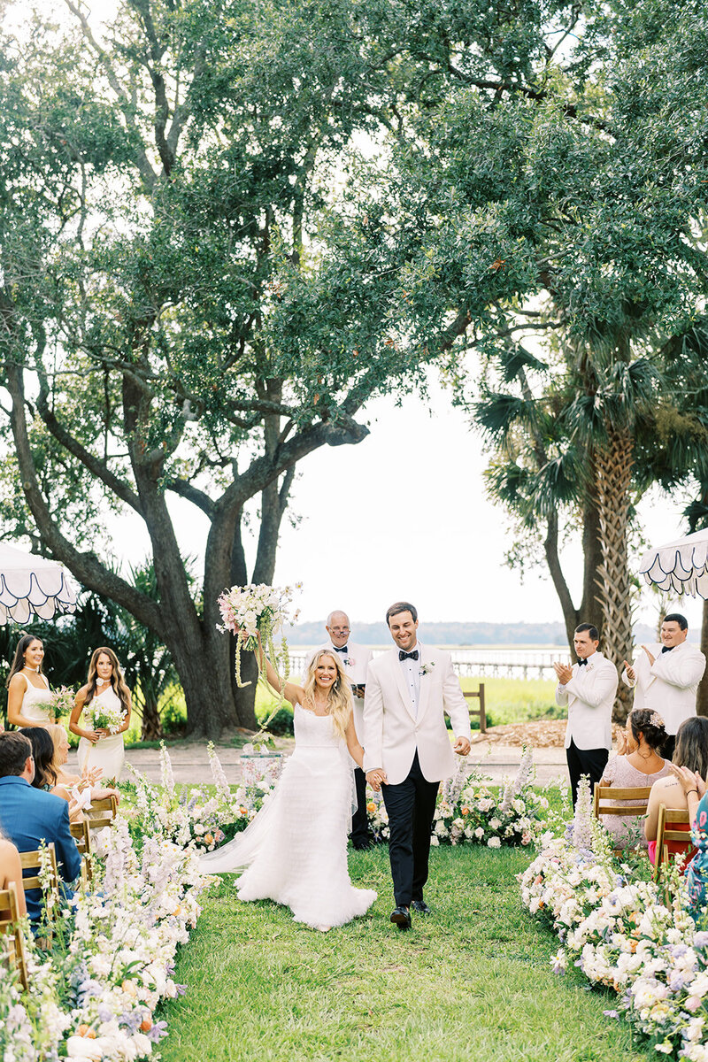 Bride and groom along the marsh on their wedding day at the Savannah Yacht Club