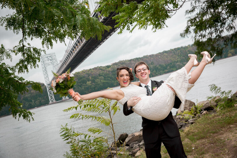 A groom holding up his bride.