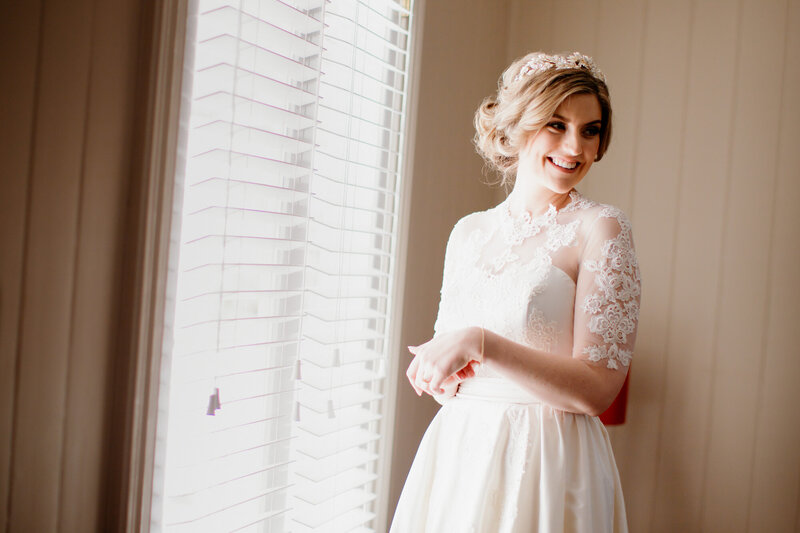 Beautiful bride standing at the window light