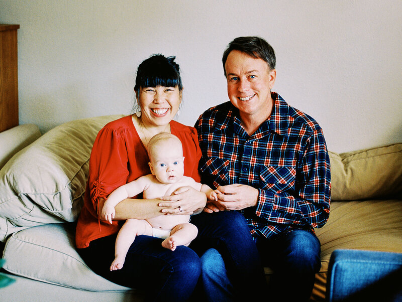 a family laughs during a photoshoot in golden, colorado