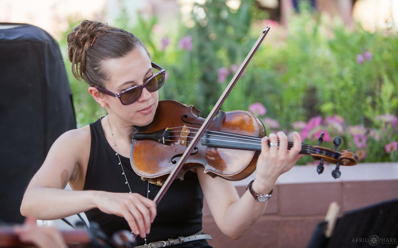 Violinist from Nexus Strings performs at an outdoor wedding at a summer wedding at Denver Botanic Gardens