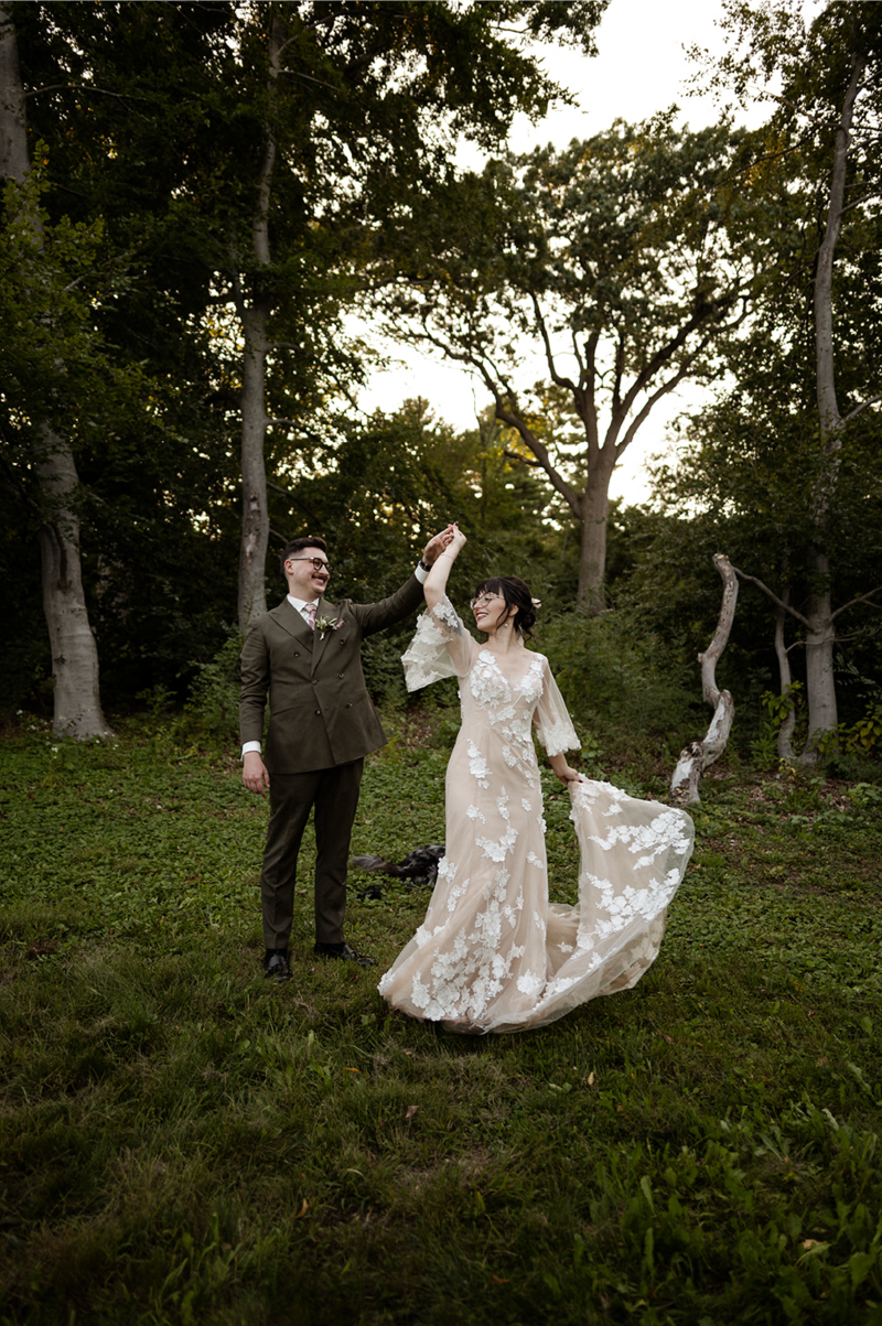 bride and groom dancing in forest