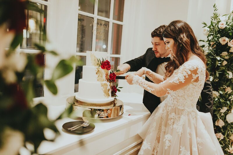 Newlyweds cutting their wedding cake