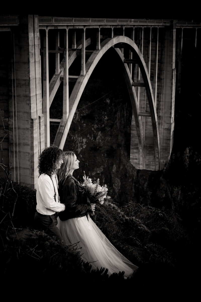 A couple celebrates their elopement at the Bixby Bridge in Big Sur.