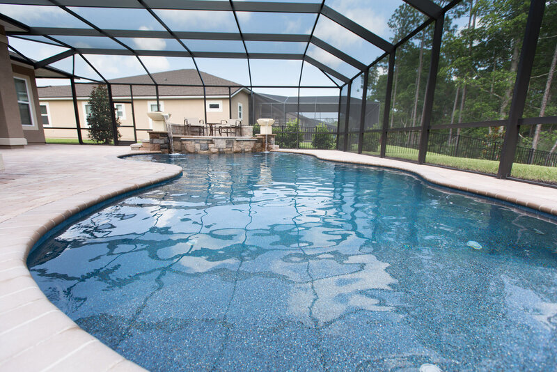 Luxury backyard and pool with screen enclosure by Southern Outdoor Spaces