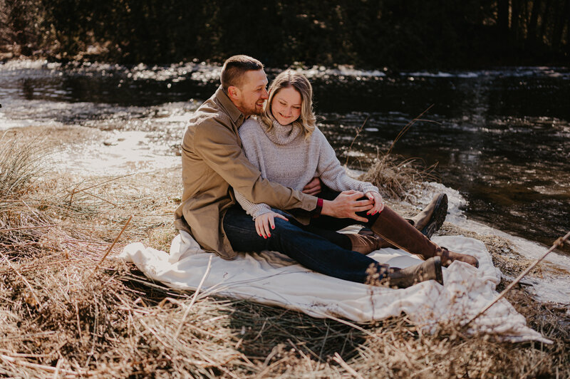 cozy engagement photos staged on blanket
