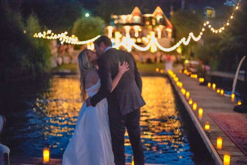 Emily John Wedding - Kiss on Dock at Night House with Lights
