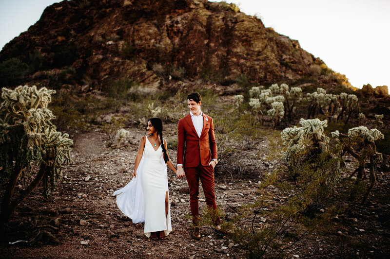 Bride and groom standing in the desert