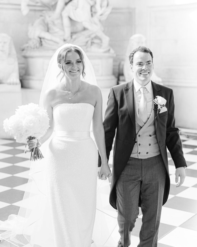 Bride and groom portrait in St Paul's Cathedral, with bride wearing Suzanne Neville and groom wearing tails