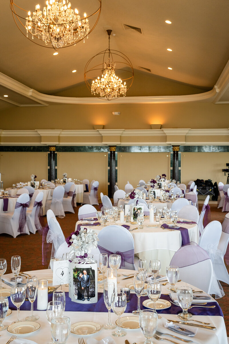 Wedding reception tables styled with lavender decor and floral arrangements – photographed by wedding photographer Niko Coric – Lumen Clarity Media