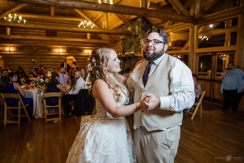 Couple dance at the Evergreen Lake House in Colorado at their fall wedding