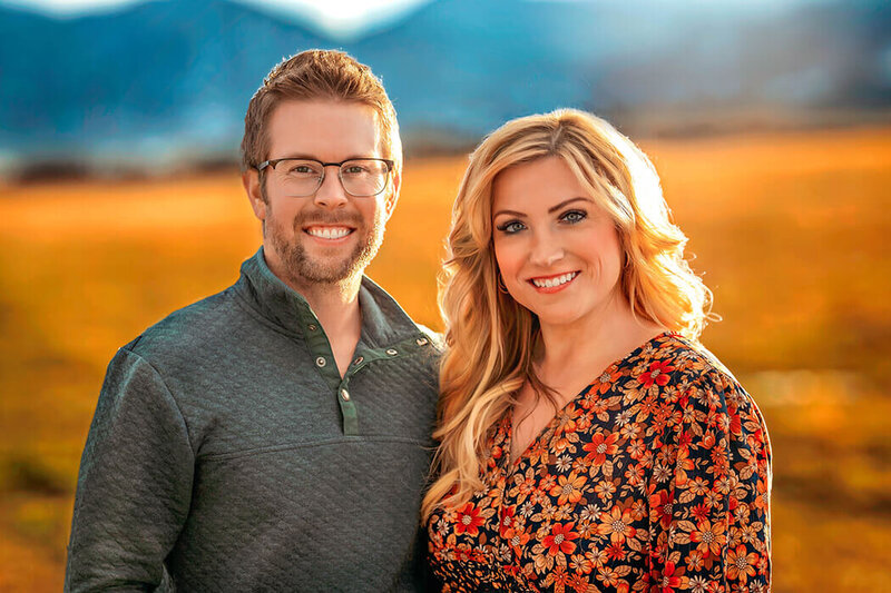 Nick and Heather headshot with rockies in the background captured by H&N Photography in Denver