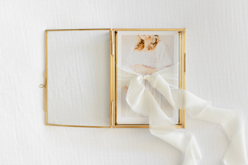 An image of a glass box of prints to store your Newborn Photographer Washington DC photos in