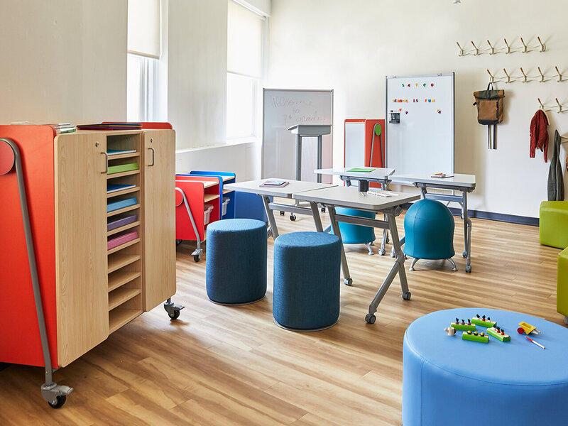 modern classroom area with fabric stools and colorful storage