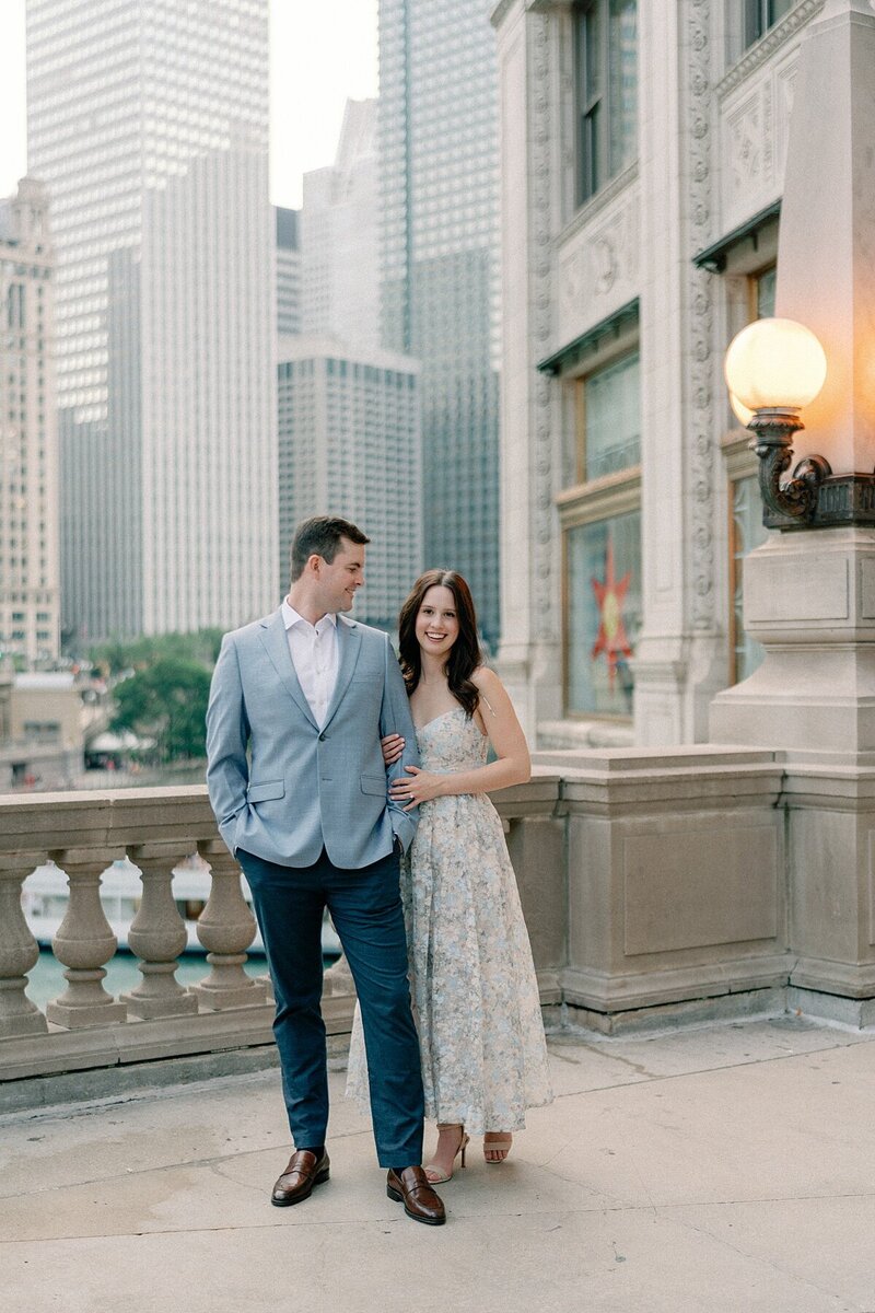 Bride and groom standing in front of the wrigley building in downtown chiago.