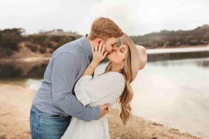 groom leans his bride over for a kiss at their engagement session in Austin, Texas.