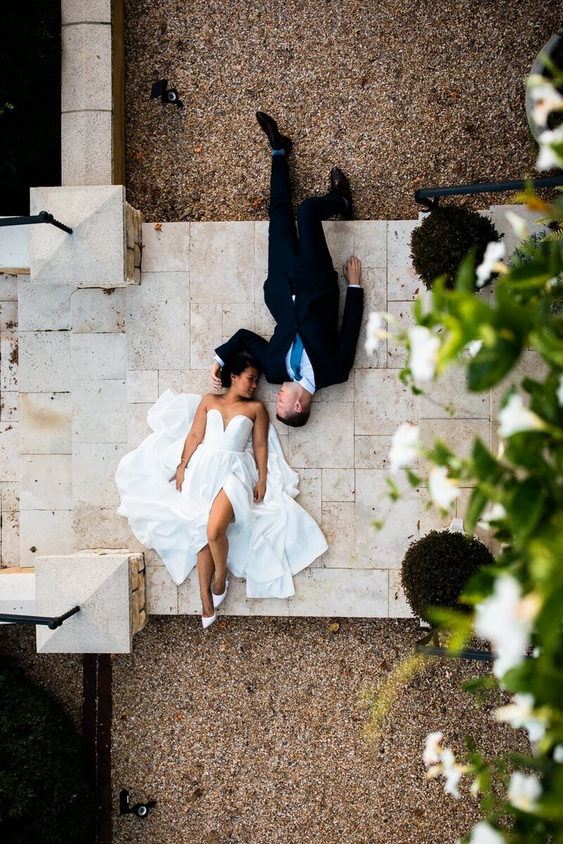 A couple lies on the ground for a creative portrait after their Central Virginia wedding
