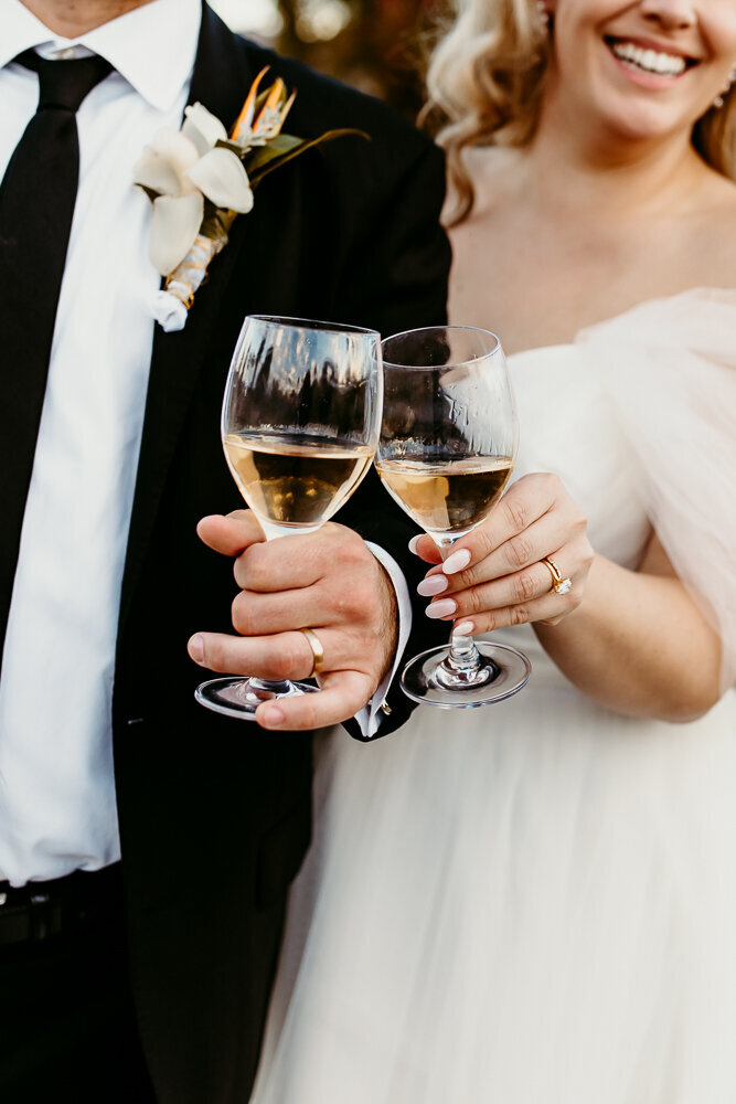 newlywed couple clinking their champagne flutes
