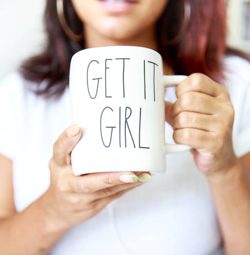 Professional woman  holding a coffee mug  while working.