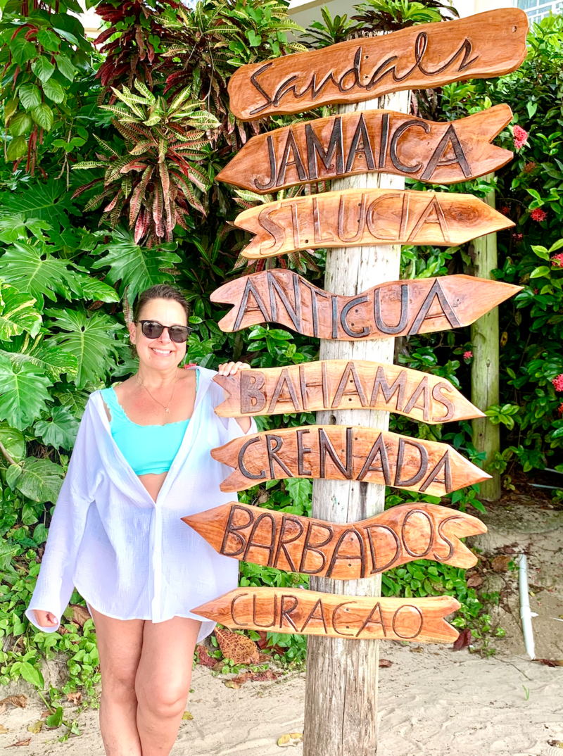 Christine Terezakis| destination wedding planner standing on dock over turquoise waters