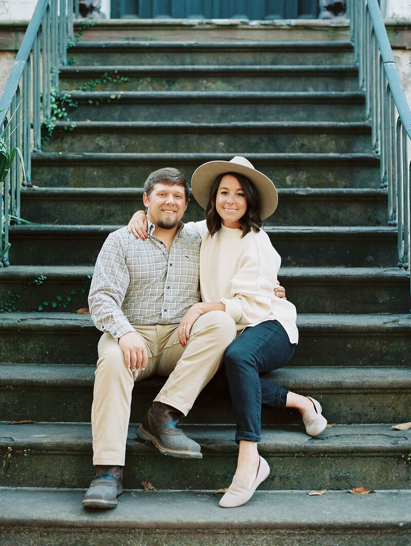 couple posing on the steps in savannah ga