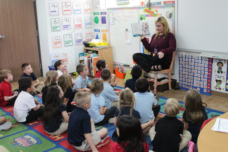 Hearn Academy teacher reading to her class while they sit on the carpet