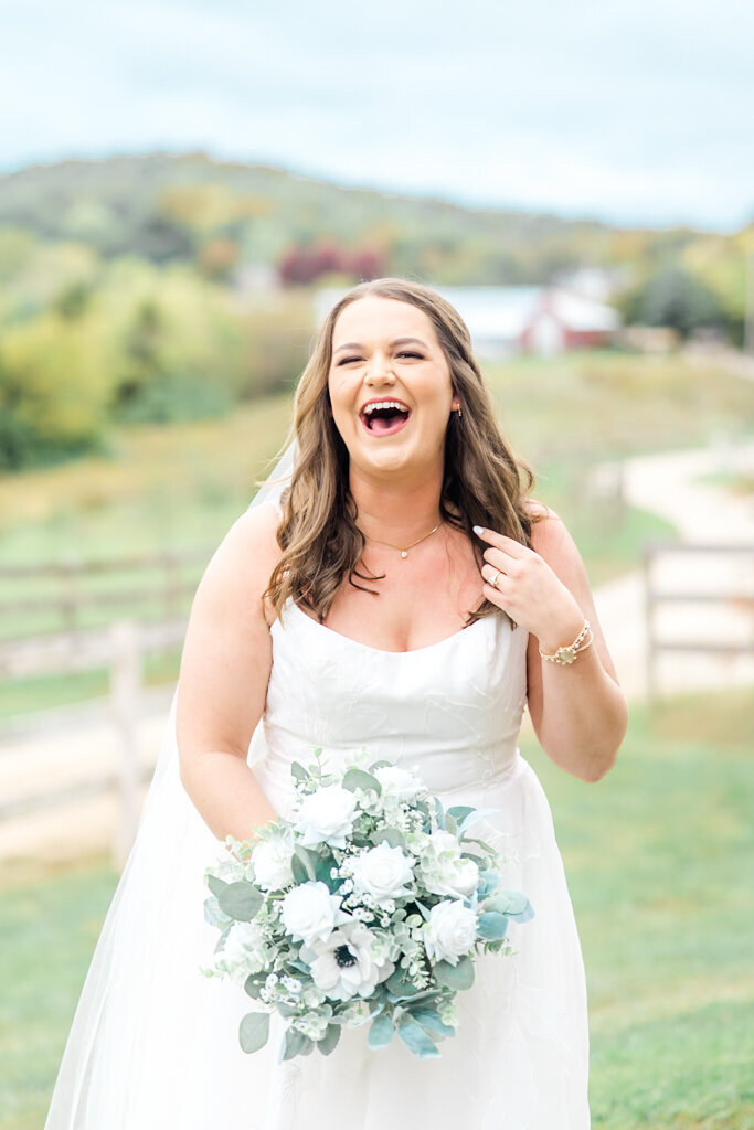 joyful bride laughing on her wedding day at Cedar Creek Lodge