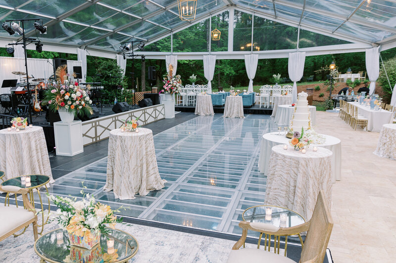 Luxury Wedding Reception at Residential Property with clear top tent and acrylic dance floor over the pool