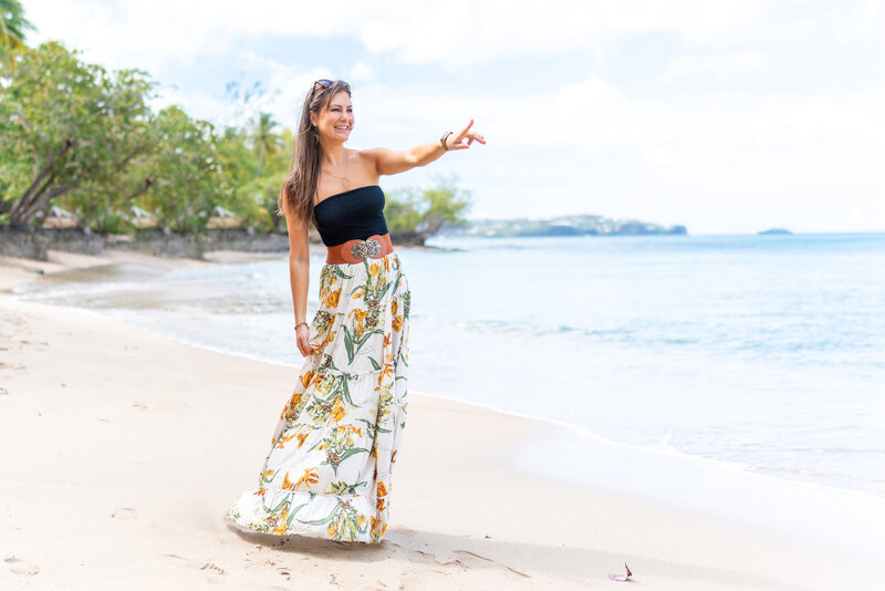 Woman on tropical beach with long skirt