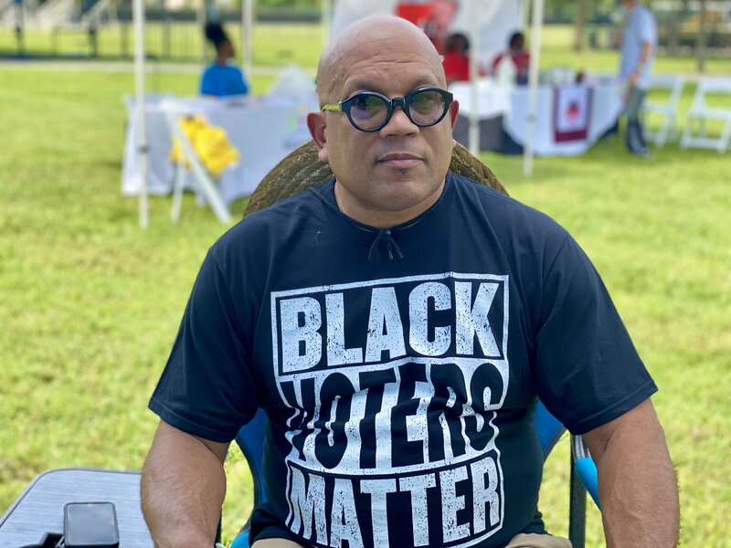 Attorney Richard Ryles on green lawn while wearing a shirt that say "Black Voters Matter"