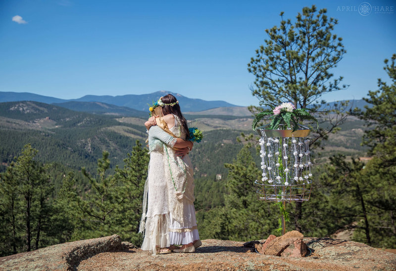 Wedding ceremony for two brides at Bucksnort Disc Golf in Pine Colorado
