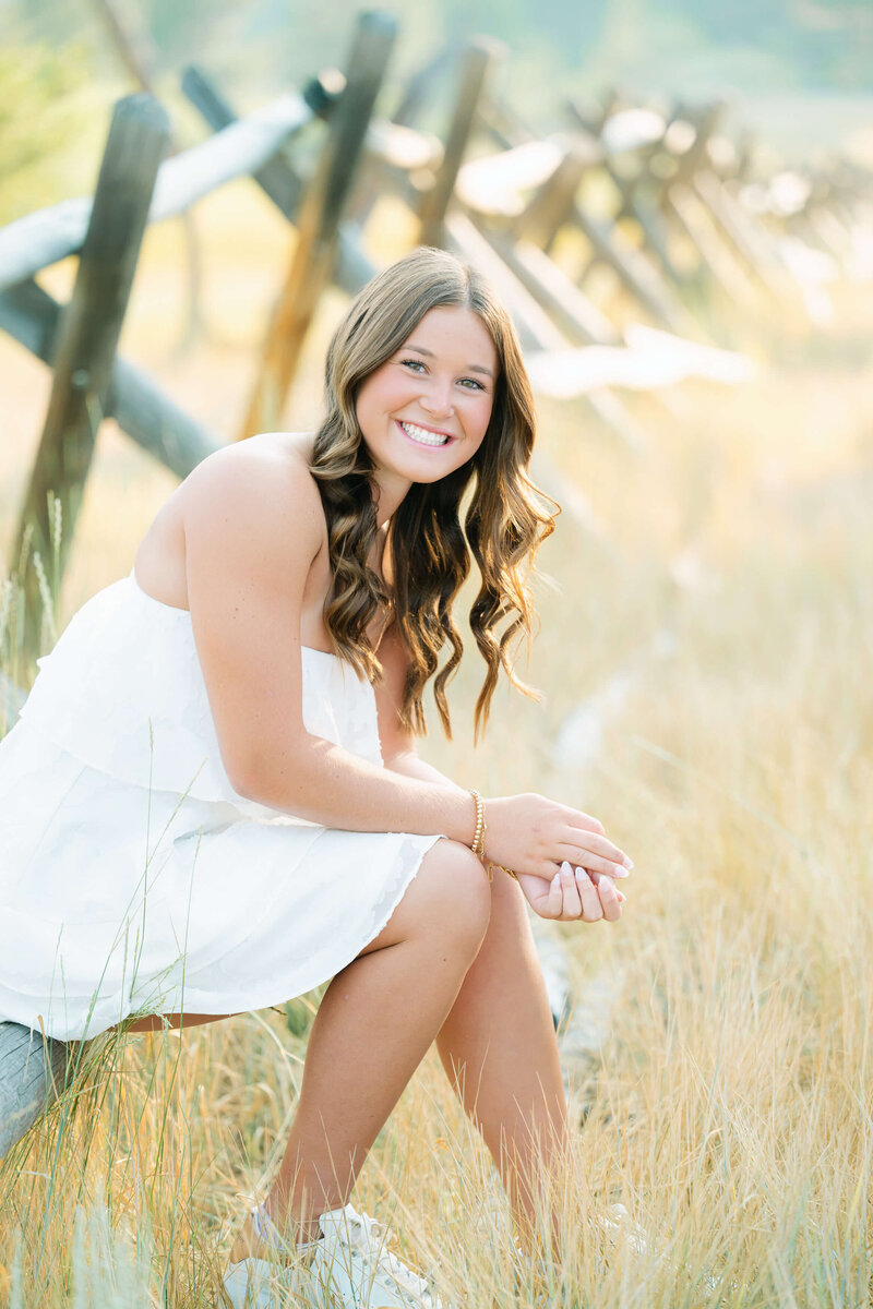Lake Tahoe grad girl session on fence in Olympic valley