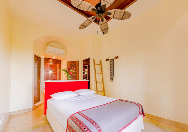 queen bed with fan white bed hermitage room blue spirit costa rica