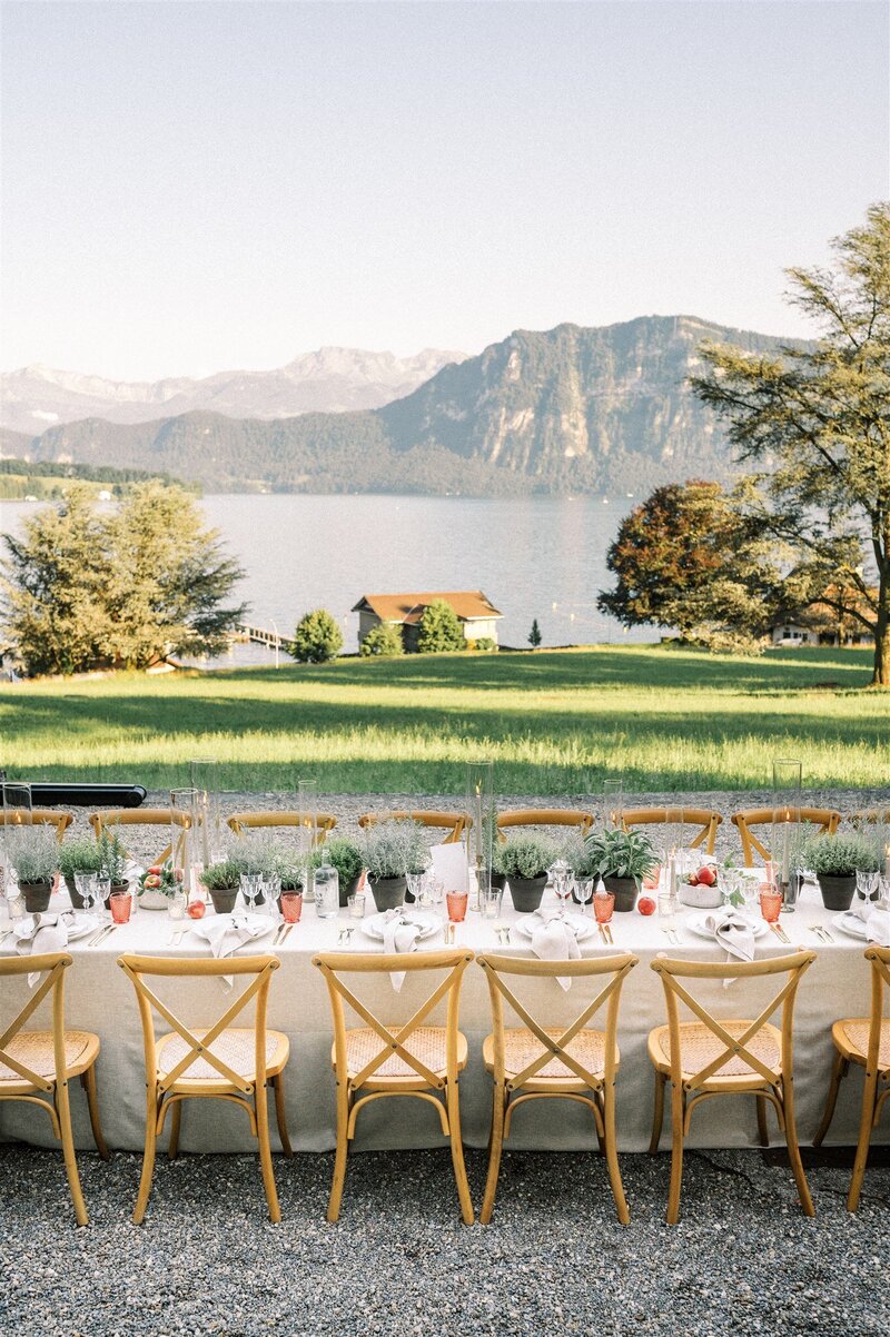 Tablesetting during a wedding at St Charles Hall, with a view to the lake and mountains