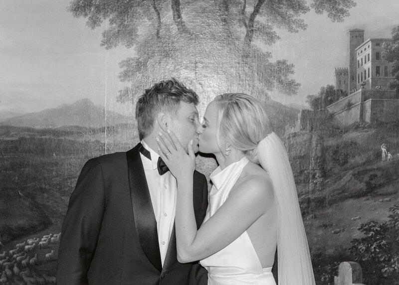 Bride and groom sharing an intimate kiss infront of a famous painting at the Oklahoma City Country Club.