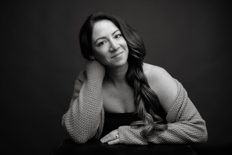 Allison McCafferty, South Jersey wedding photographer posing for a photo with her hair over her shoulder