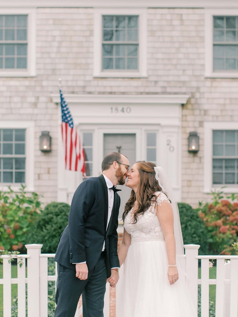 Bride and groom kiss outside New England venue