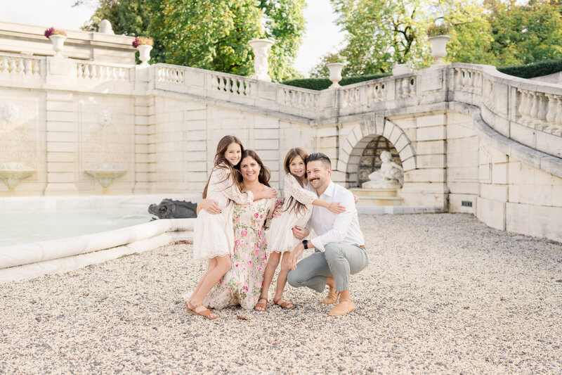 A family poses in front of the fountain at Nemours Estate in Wilmington, Delaware.
