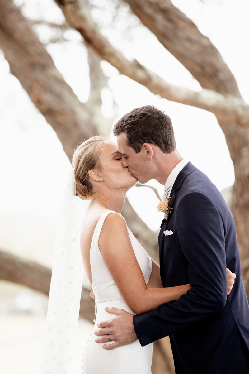 Bride and Groom kiss at Wedding Ceremony