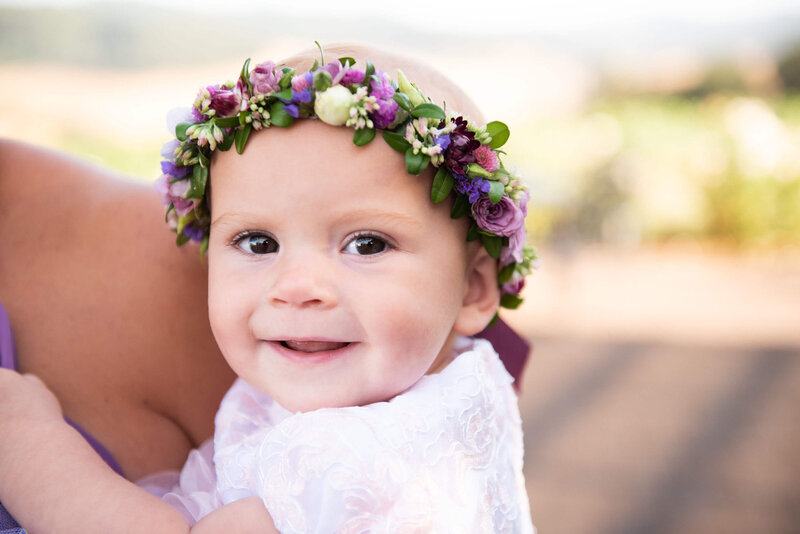 Baby smiling and wearing a flower crown