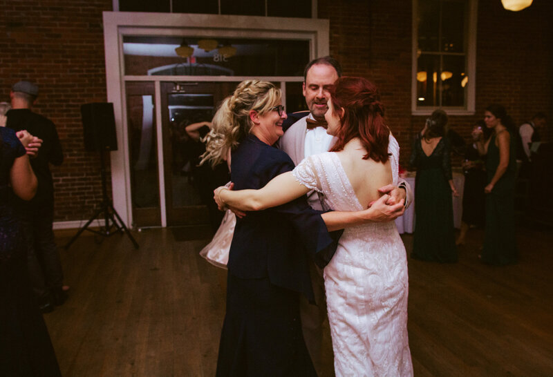 bride hugging her mother and father