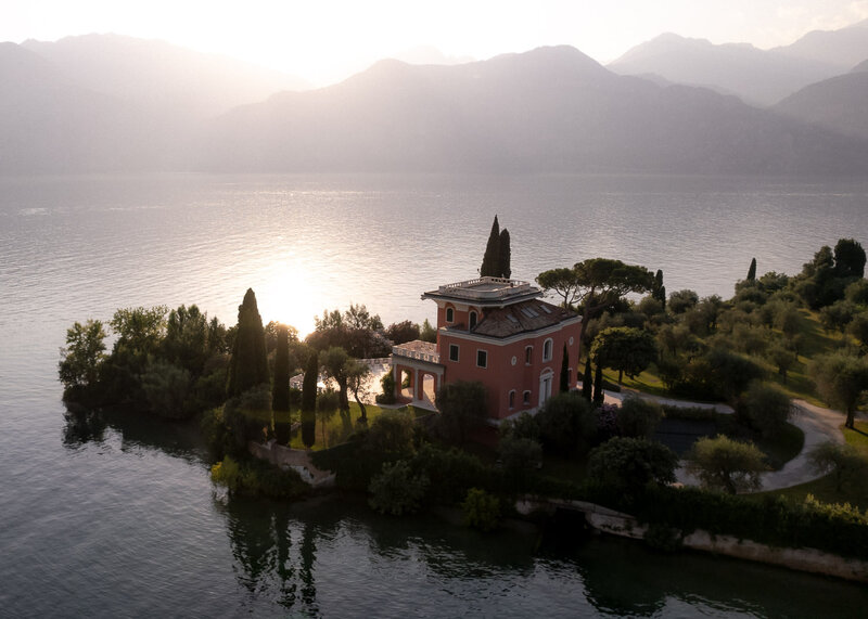 Villa at Lake Garda captured vom above with sun setting in background