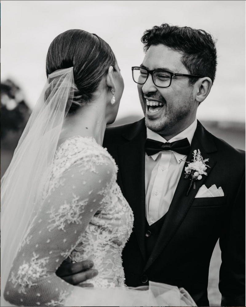 black and white image of couple laughing on their wedding day