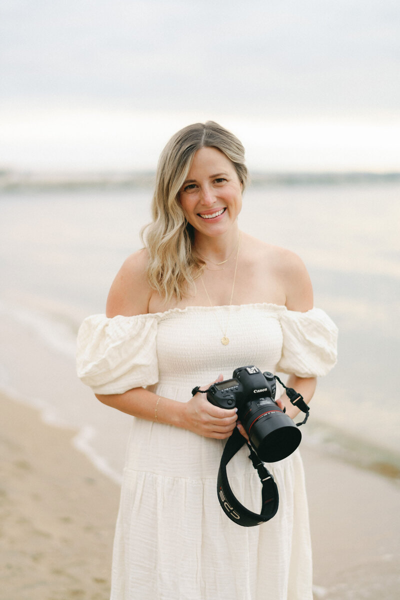 Amy Dunkel on the beach with camera