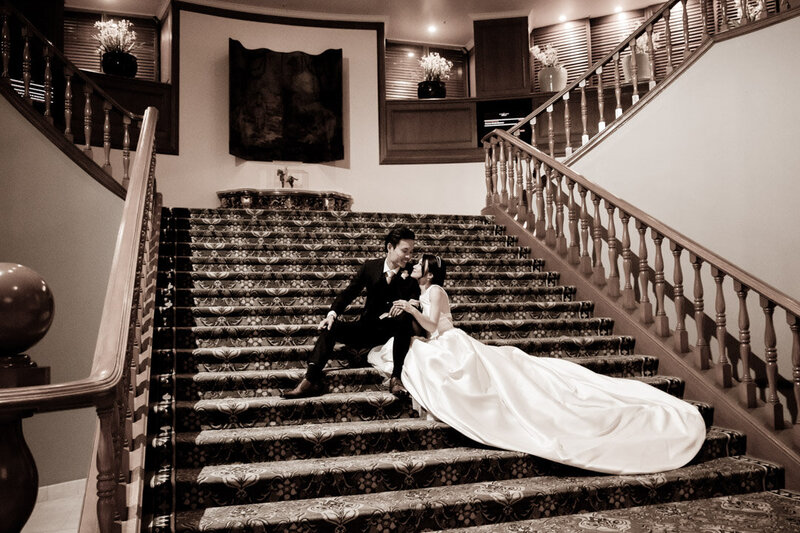 Wedding couple sitting on the staircase