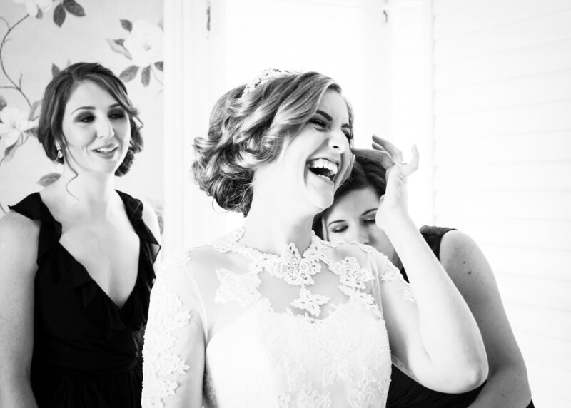 Bride laughing with bridesmaids