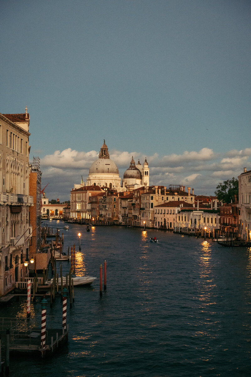 Sunset view from Accademia Bridge in Venice, capturing the tranquil beauty of the city as the sun sets, casting a warm glow over the iconic canals