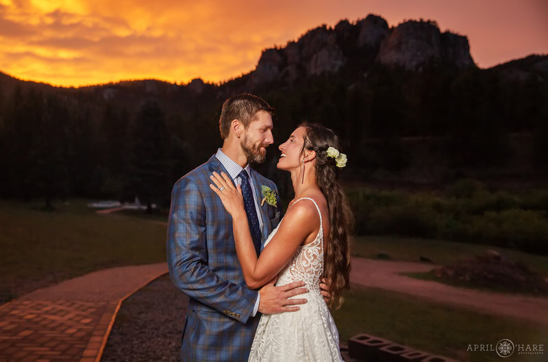Gorgeous orange sunset sky on a summer wedding day at Mountain View Ranch in Pine