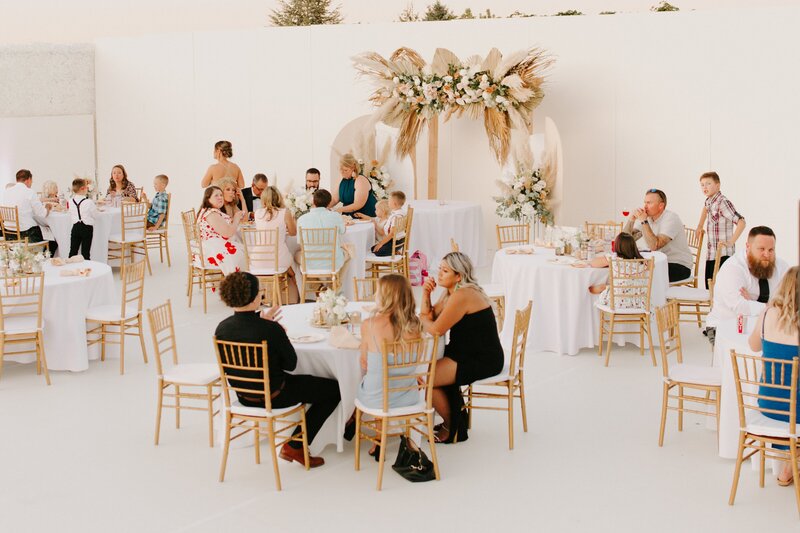 Guests Seated at Reception Tables - Bre & Chris | Converted Basketball Court Wedding – Featured in Brides Magazine